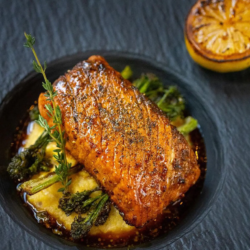 Vegan plant-based salmon filet on a plate with charred lemon