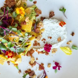 Vegan coconut based bacon bits on a plate with colorful flowers by Madly Hadley