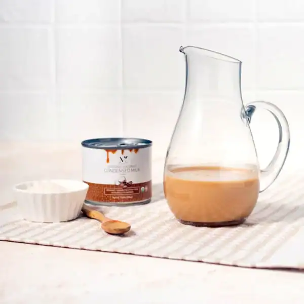 vegan plant based coffee coconut condensed milk in a glass pitcher