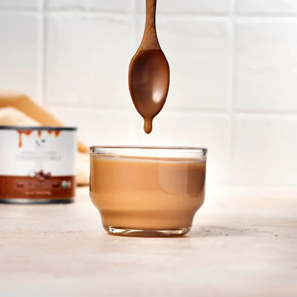 Vegan plant based coffee flavored coconut condensed milk dripping off spoon