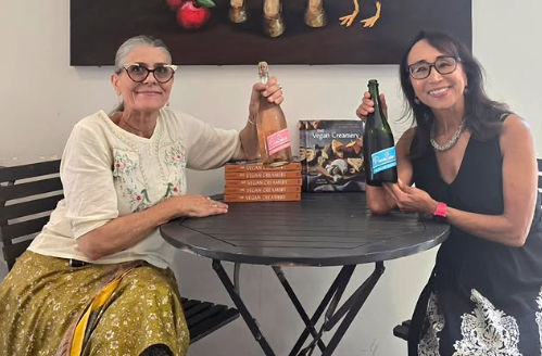 Jennifer Golden, owner of The Vreamery, standing next to Miyoko Schinner at an in-person vegan cheese tasting and book signing event