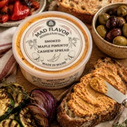 Smoked Pimento and Maple spread on a piece of bread on a board with accoutrement