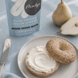 Monty's vegan cream cheese on a bagel with a pear