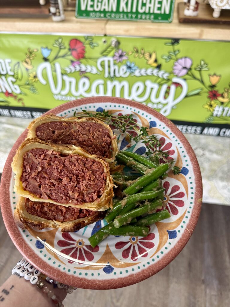 vegan roast on a plate with vegetables and a blurred background