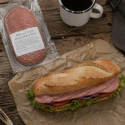 Midcoast Vegan Honey Baked Ham subway sandwich on a cutting board