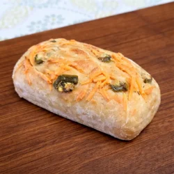 a vegan sourdough mini loaf spicy senorita flavor on a wood board