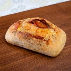 a vegan sourdough mini loaf pizza flavor on a wood board