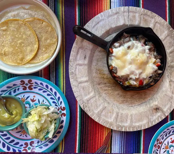 Cheese Sauce in a pan with tortillas and sides