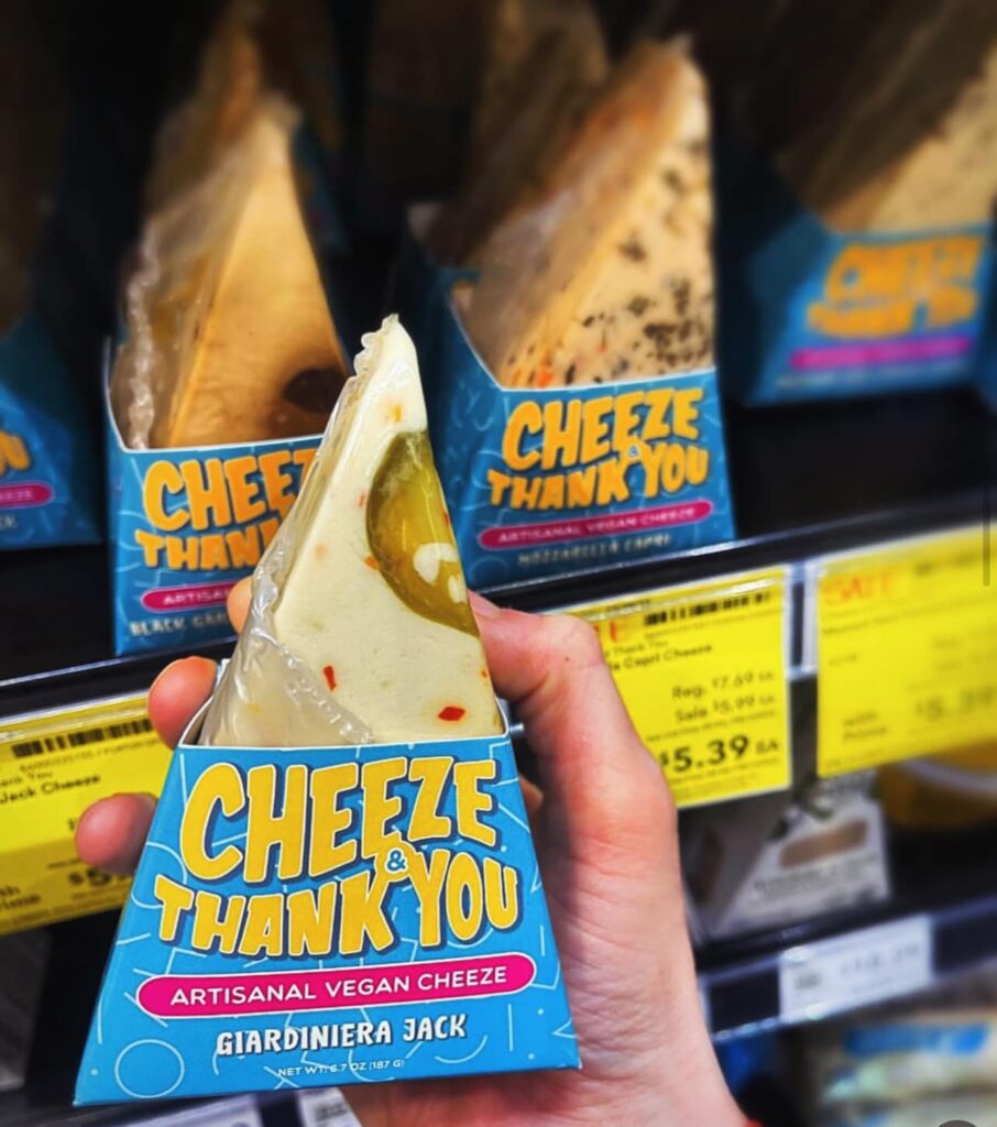 Cheeze & Thank you gourmet plant-based cheese products on display at a retail shopping store. 