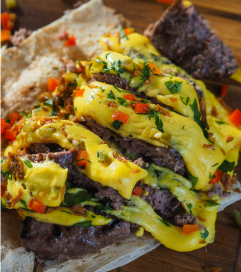 Melted vegan cheese on meat tacos